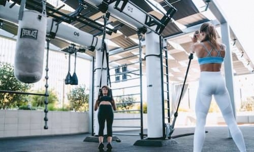 two women outside working out